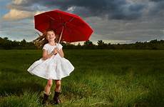 cloudy field umbrella moody jumping red