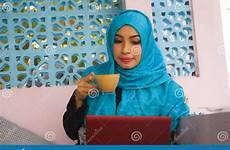 hijab networking scarf muslim laptop having internet computer working head using woman happy fun beautiful islam indonesian