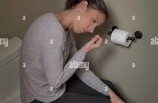 toilet sitting woman lid young her stock closed alamy