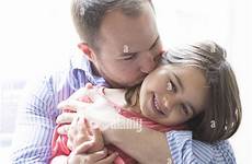 kissing little daughter lap father holding girls alamy girl cheek stock his two her