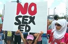 ed sex protest delay curriculum trustees catholic want demonstrators hold sign