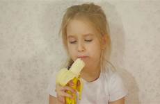 eating girl young banana stock storyblocks sitting