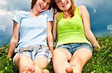 barefoot girl young teenage two sitting friends summer meadow alamy stock