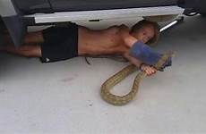 snake woman boa constrictor stuck kill face ohio bbc firefighters unsupported playback device