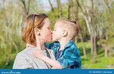 mom boy kisses spring park her little
