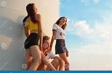 tieners hete twee zitten dichtbij meisjes kerel hemelachtergrond blauwe windmolen