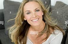 mature blonde woman smiling portrait stock alamy