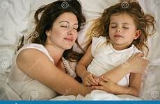 mother bed sleeping daughter asleep embracing together preview