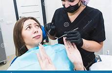 dentist dental woman teeth feels fear clinic examination patient reception care young hurt does do clean preview cleans