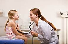 doctor giving girl office checkup baby stock five high