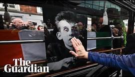 Mourners sing at Shane MacGowan's funeral procession