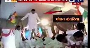 BJP candidate Mohan Kundariya walks over children during a yoga event