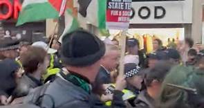 Michael Gove surrounded by pro-Palestinian protestors shouting 'shame on you'