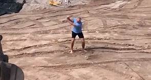 Greg Norman shows off his impressive golf swing in huge dirt hole