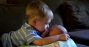 Landon kissing his new baby brother