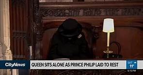 Masked and mourning, Queen sits alone as Prince Philip is laid to rest