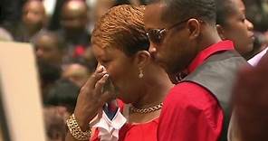 The family of Michael Brown walks into his funeral service