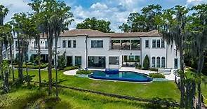 This $6,670,000 Elegant Home in Orlando has a resort style backyard and a stone driveway