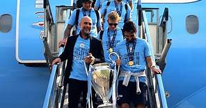 European Champions Manchester City arrive back in UK with Champions League trophy