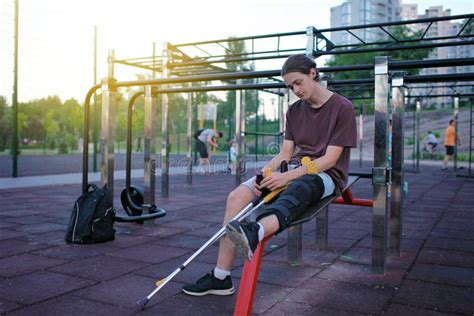 Disabled Young Man On Crutches With Knee Orthoses Stock Photo Image