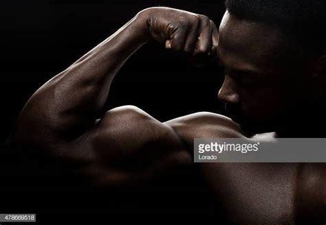 African American Man Flexing Biceps Photos And Premium High Res