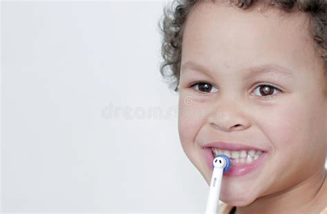 Boy Brushing His Teeth With An Electric Tooth Brush Stock Photo Stock