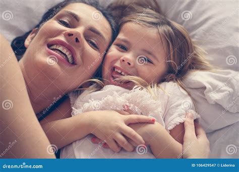 mother and daughter playing in bed stock image image of adult headshot 106429547