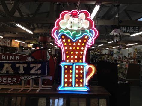 A Large Neon Sign In The Shape Of A Giant Ice Cream Cone On Display At
