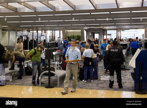 Travelers pass through airport security checkpoint, TSA, Tampa
