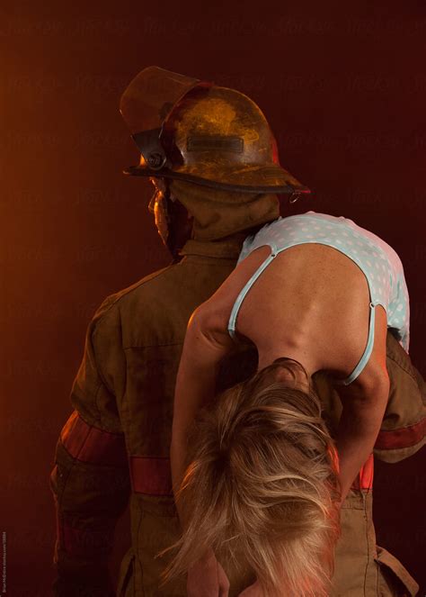 Fireman Carrying Woman From Buring Building By Brian Mcentire Stocksy