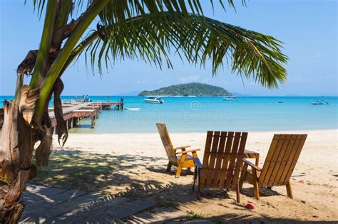 Tropical Beach Panorama With Deckchairs Boats And Palm Tree Stock
