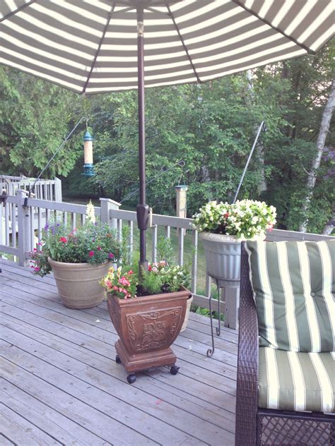 These patio table umbrellas come in round, square and rectangular shapes held by a pole in the middle. Rolling, flower pot/deck umbrella stand | My Style ...