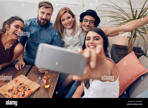 Multiracial People Having Fun At Party Taking A Selfie With Mobile