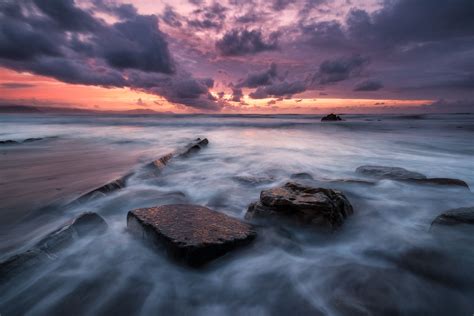 Sunset Over Rocky Sea By Jokin Romero