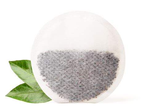 Round Tea Bag And Fresh Green Leaves On White Background Isolated