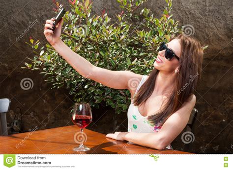 girl wearing shades and drinking wine taking selfie stock image image of restaurant glasses
