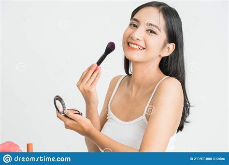 Beautiful Young Woman Applying Foundation Powder Or Blush With Makeup