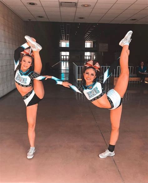 Two Cheerleaders Are Posing For The Camera