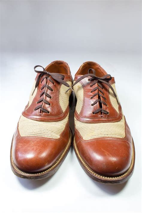 Pair Of Men`s Vintage Leather And Net Wing Tip Shoes On White Stock