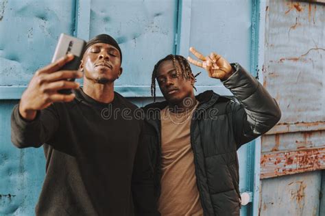 Shallow Focus Of Two Black Men Taking A Selfie Together Outside A