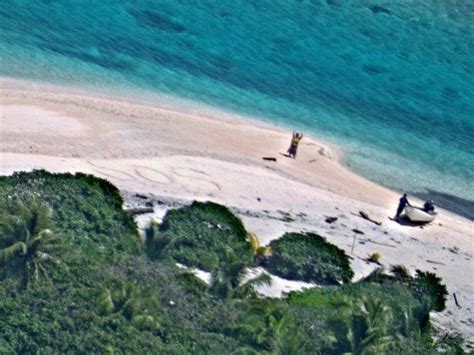 micronesia castaways rescued from desert island after writing sos in sand