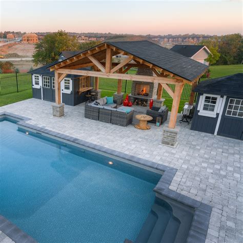 An Outdoor Living Area Next To A Swimming Pool And Covered Patio With