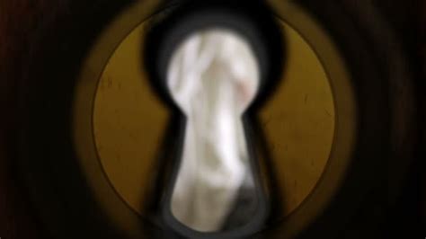 girl peeping through a keyhole woman unsharp ⬇ video by © kopitin stock footage 112897638