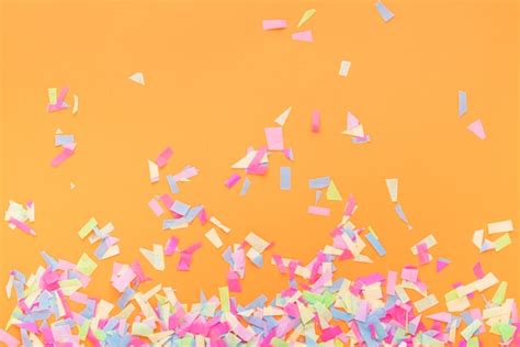 Free Photo Colorful Confetti On A Orange Background