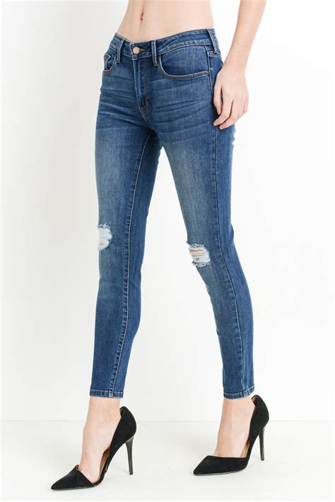 Mid Rise Dark Denim Skinny Jeans With Distressing At Maria Vincent Boutique