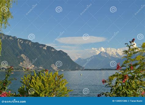 Panoramic View On Geneva Lake Mountains Hills Greenery And Blue Sky
