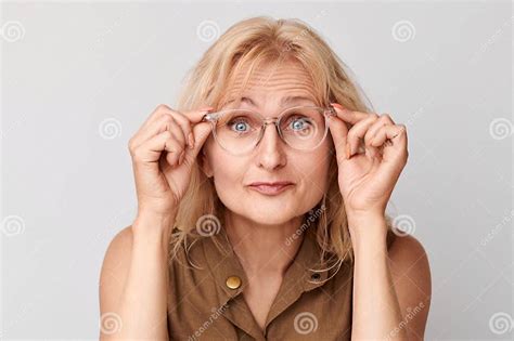 Portrait Of Lady Squinting In Glasses On Studio Background Vision