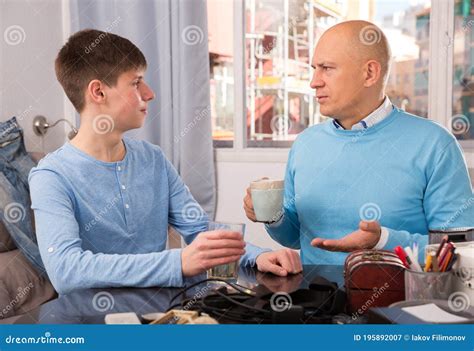 Father And Son Enjoying Conversation Stock Image Image Of Interior
