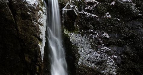 Waterfalls In Between Gray Rocks · Free Stock Photo