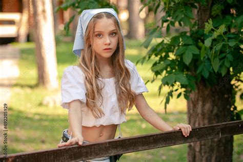 Pretty Teenage Girl Posing Near Fencing In Summer Country Estate Stock